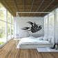 Scorpion wall decal, black design on light wall above bed