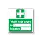 First aid sticker with green cross and text 'Your first aider is located'