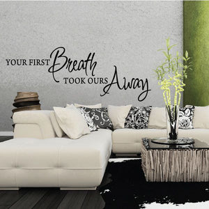 Wall decal with cursive quote: “Your first breath took ours away”