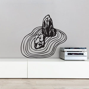 Zen garden decal with raked sand lines and stacked rock shapes in black outline