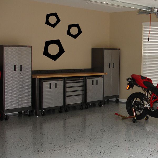Three black nut decals with round center holes
