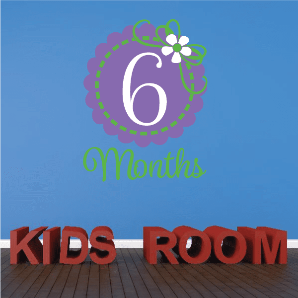 Purple 6-month wall decal with flower and green text, plus KIDS ROOM letters