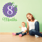 8-month wall decal with purple number 8, green months script, and white flower accent