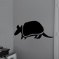 Armadillo wall decal with abstract black silhouette, curved armor shell and long tail.