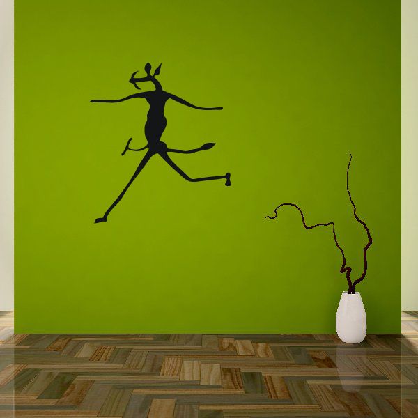 Dancer wall decal: black silhouette with arms spread and flowing dress, on green surface.