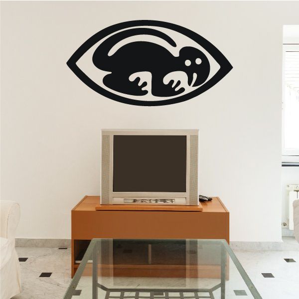 Lizard eye wall decal in black and white with white dots and curved eyelid lines