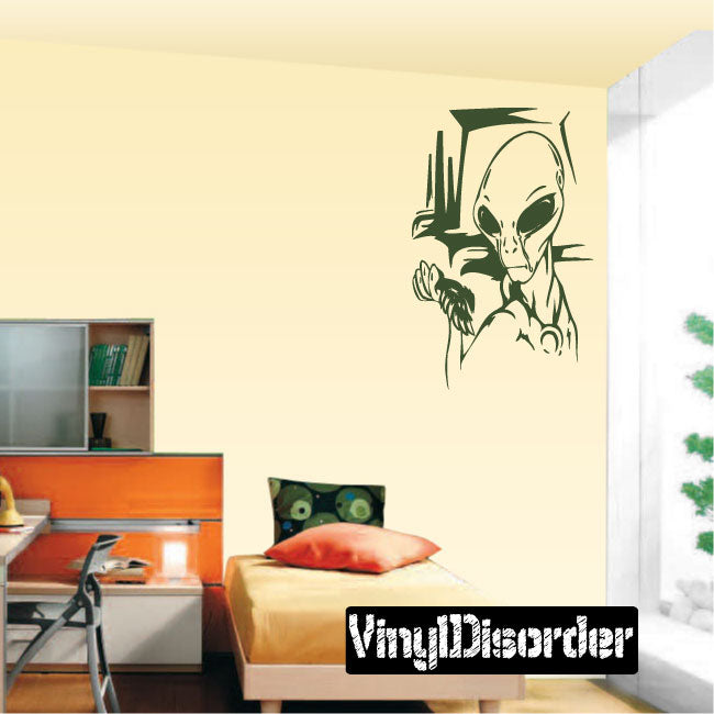 Green alien vinyl wall decal with raised hand and stylized head