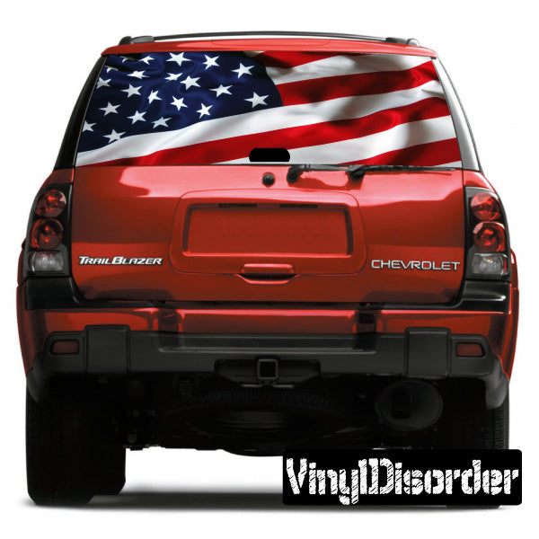 Red SUV rear window with large American flag graphic decal and Chevrolet Trail Blazer badges