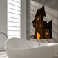 Haunted house die-cut decal in black with orange glowing windows and door