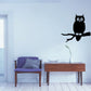 Black owl on branch wall decal with wide eyes and beak
