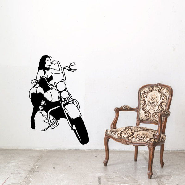Black vinyl wall decal of girl on motorcycle with helmet and lifted arm