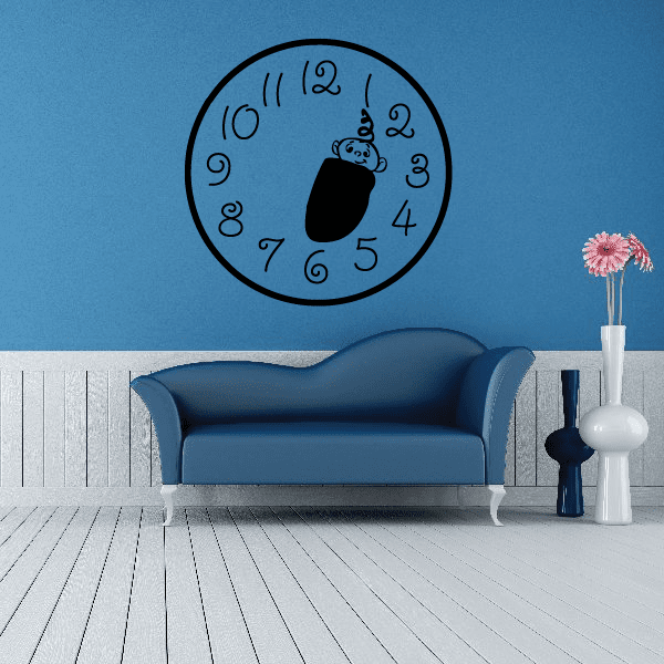 Black-outlined wall clock decal with baby holding toy, numbered 1–12