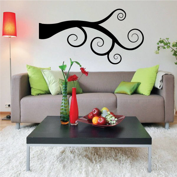 Black tree branch wall decal with curled vine swirls and small buds