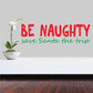 Wall printed decal: red 'BE NAUGHTY' and green 'save Santa the trip' text