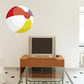 Beach ball wall sticker with red, yellow, and blue segments and brown center