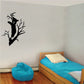 Bear cub hugging tree wall decal in black silhouette with bare branches