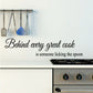 Wall decal with black cursive quote: “Behind every great cook is someone licking the spoon”