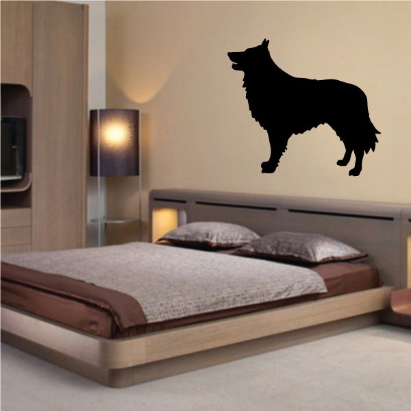 Black Belgian Shepherd dog silhouette decal on wall above bed