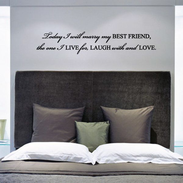 Marriage quote wall decal with cursive text, black lettering on light wall above bed
