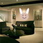 Easter bunny head sticker with smiling face, upright ears, light pink and white