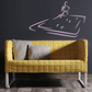 Yellow upholstered sofa with quilted texture and two throw pillows