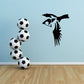 Black bird mid-flight wall decal next to soccer balls