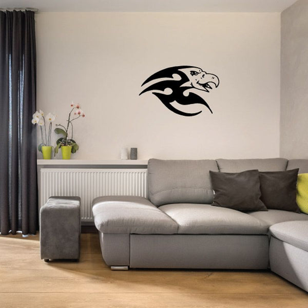 Black bird vinyl wall decal with wings spread, sitting on a wall.
