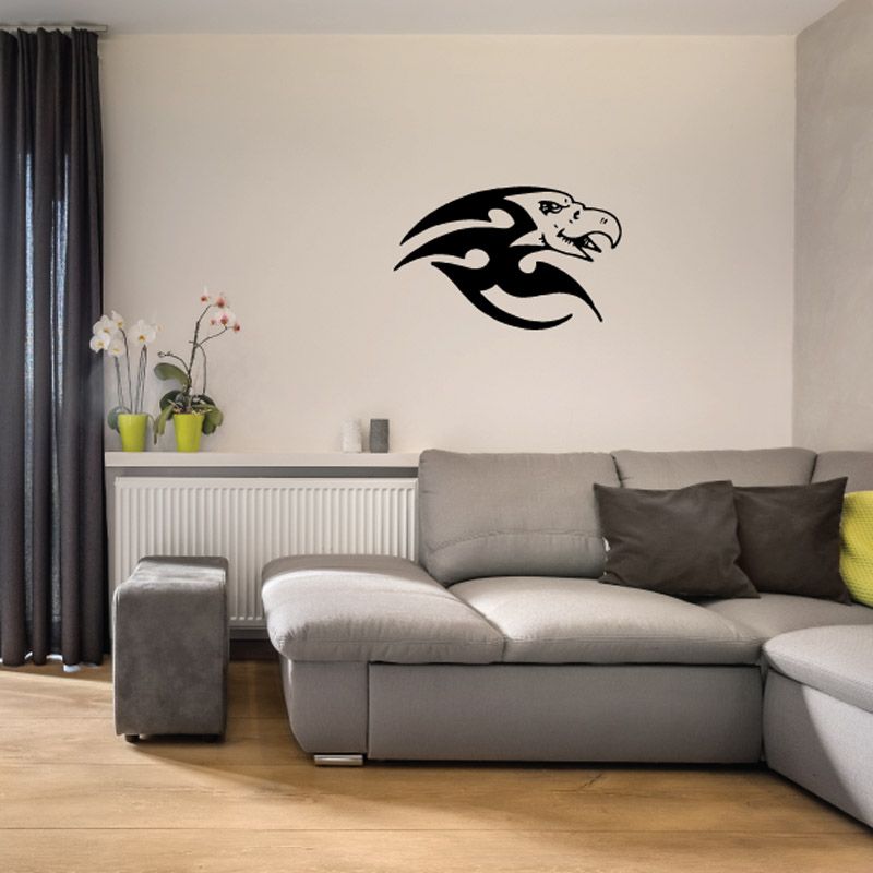 Black bird vinyl wall decal with wings spread, sitting on a wall.