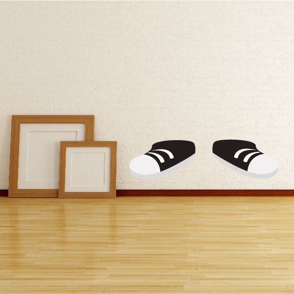 Black and white shoes sticker with a pair of stylized sneakers, black uppers and white soles.