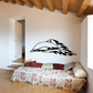 Dolphin wall decal with black flame-like tail and swooping body