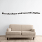 Wall decal with script text: “Bless this House with Love and Laughter”
