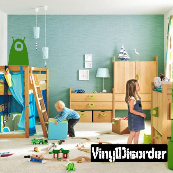 Green blob alien decal with one large eye, single tentacle shape on wall