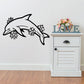 Dolphin wall decal with blooming flower outlines, black design on light surface