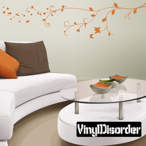 Vinyl branch wall decal with flowing vines and orange leaf accents