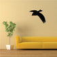 Black descending bird decal, flying silhouette on a wall