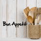 Handwritten Bon Appetit decal in black script on light surface
