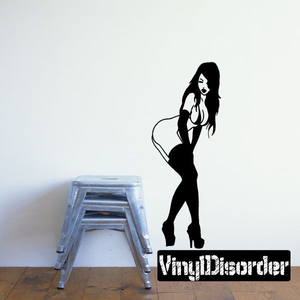 Silhouette wall decal of a woman in black dress and heels, fixing stockings
