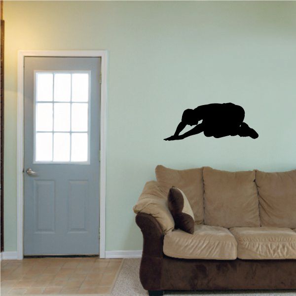 Black praying wall decal of a bowed kneeling figure