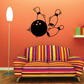 Bowling strike wall decal with a black bowling ball and two orange pins