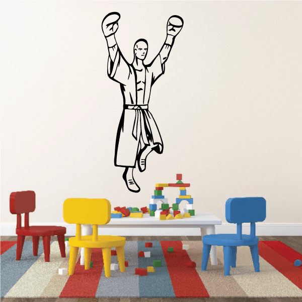 Boxing wall decal of a standing woman with raised gloves, vinyl sticker