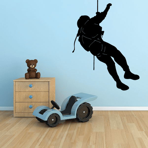 Black vinyl wall decal of superhero silhouette hanging from pole