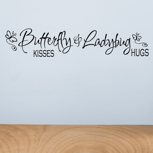 Wall decal with butterfly and ladybug icons and text: Butterfly Kisses, Ladybug Hugs