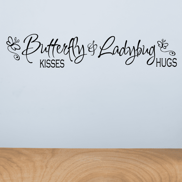 Wall decal with butterfly and ladybug icons and text: Butterfly Kisses, Ladybug Hugs