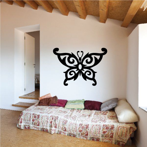 Black tribal butterfly wall decal with ornate wing flourishes.