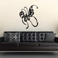 Butterfly wall decal with ornate black wings and curled filigree lines