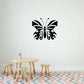 Black butterfly wall vinyl decal with detailed wings, centered above a table.