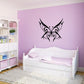Butterfly wall decal, black ornate butterfly design on a wall above a white bed