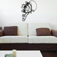 Butterfly vinyl wall decal with black outline and decorative swirls
