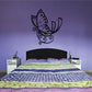 Black butterfly wall decal with dotted wings and curled filigree accents