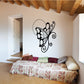 Black butterfly wall decal with white-dotted wings and swirling antennae
